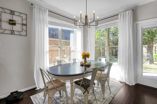 a kitchen with stainless steel appliances granite countertop a refrigerator and a stove top oven with wooden floor