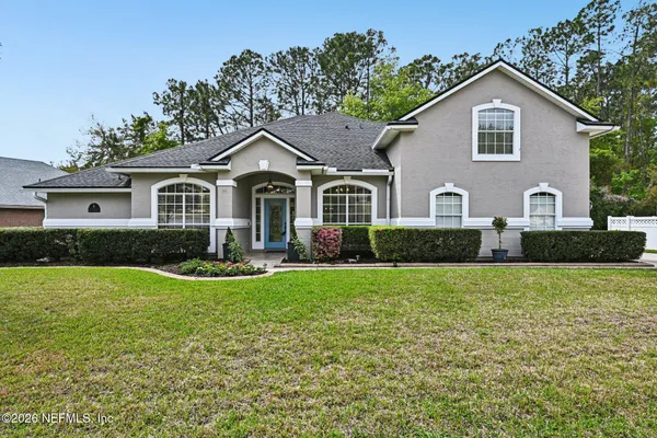 a front view of a house with a yard and garage