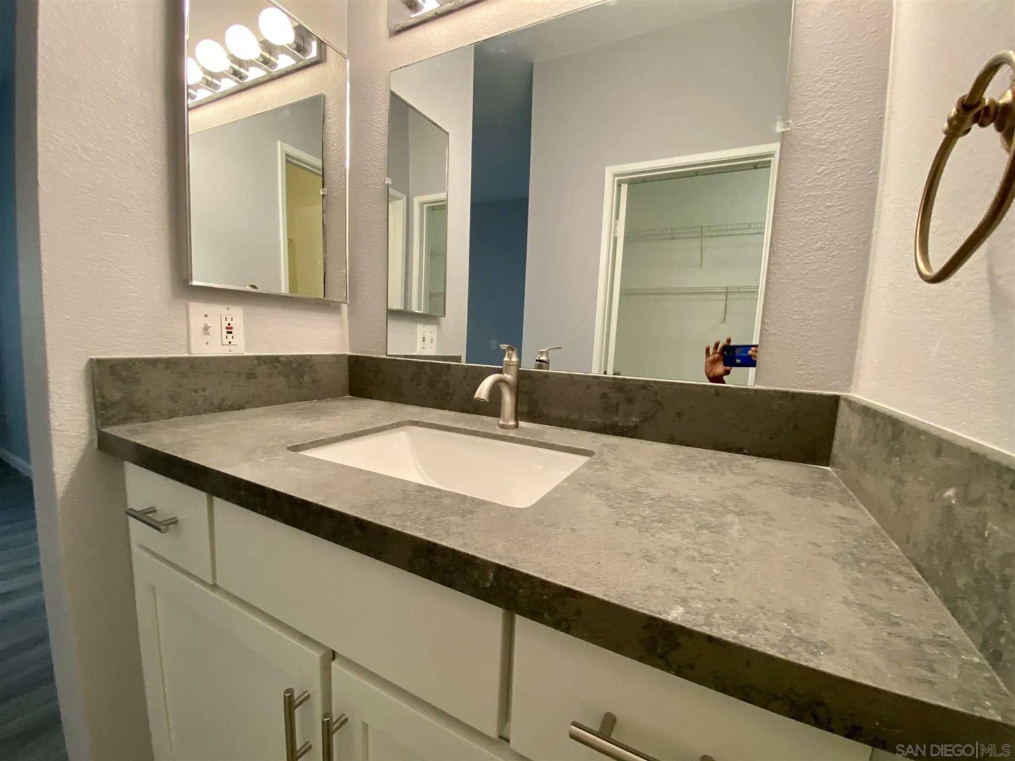 17161 Alva Road, Unit 213 San Diego, CA 92127 - Photo 13 of 48 a bathroom with a sink and a mirror