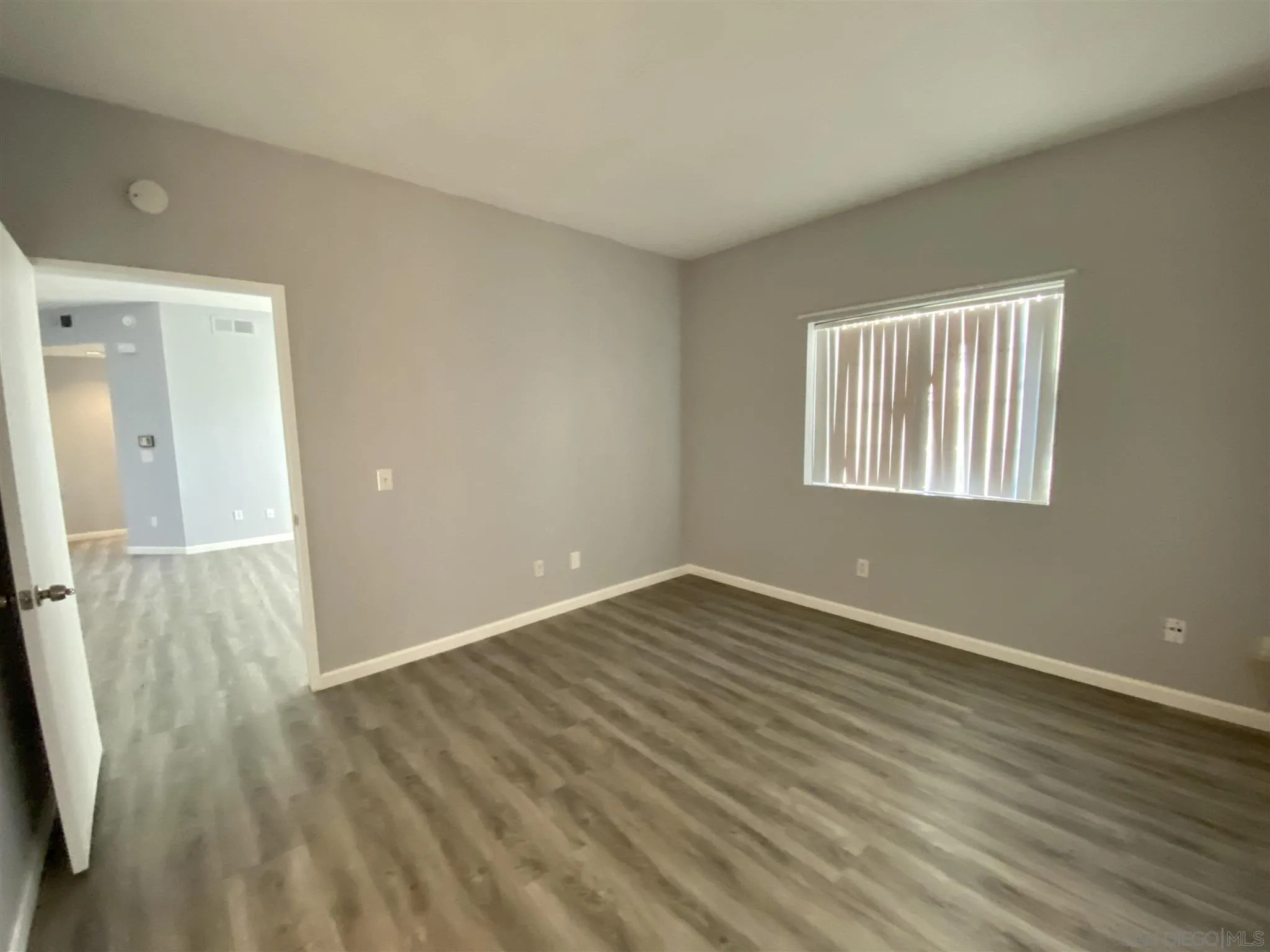17161 Alva Road, Unit 213 San Diego, CA 92127 - Photo 14 of 48 an empty room with wooden floor and windows