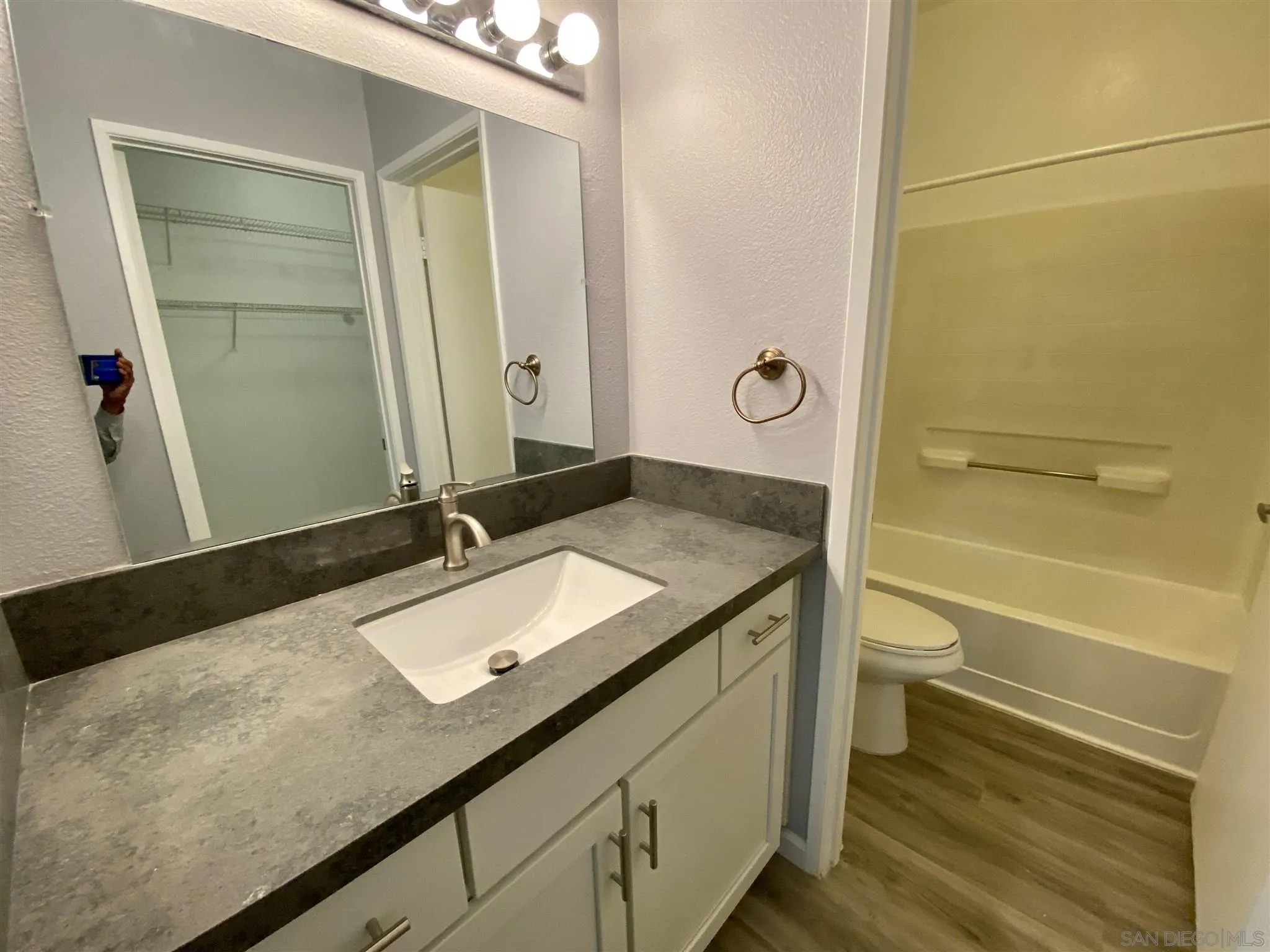 17161 Alva Road, Unit 213 San Diego, CA 92127 - Photo 15 of 48 a bathroom with a granite countertop sink and a mirror