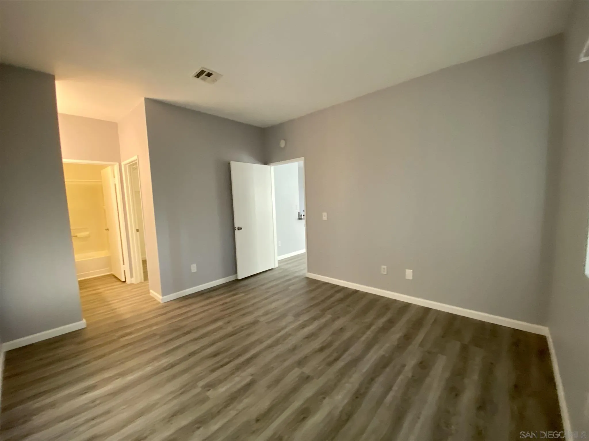 17161 Alva Road, Unit 213 San Diego, CA 92127 - Photo 28 of 48 a view of an empty room and wooden floor