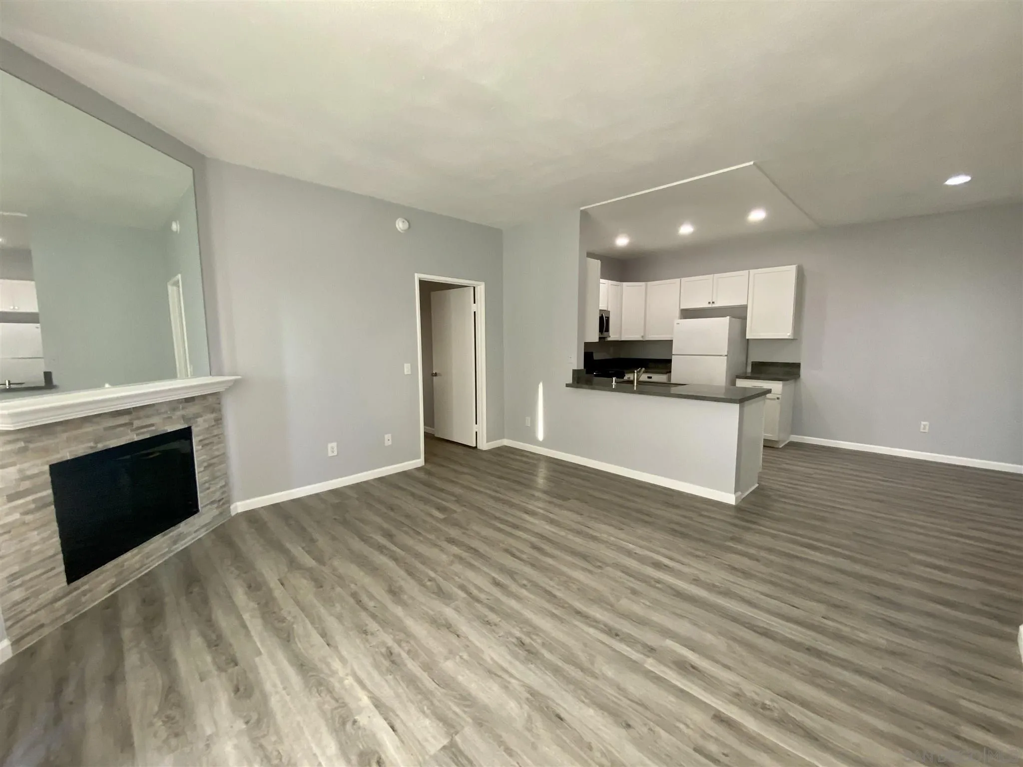 17161 Alva Road, Unit 213 San Diego, CA 92127 - Photo 30 of 48 a view of a kitchen with a sink cabinets and a fireplace