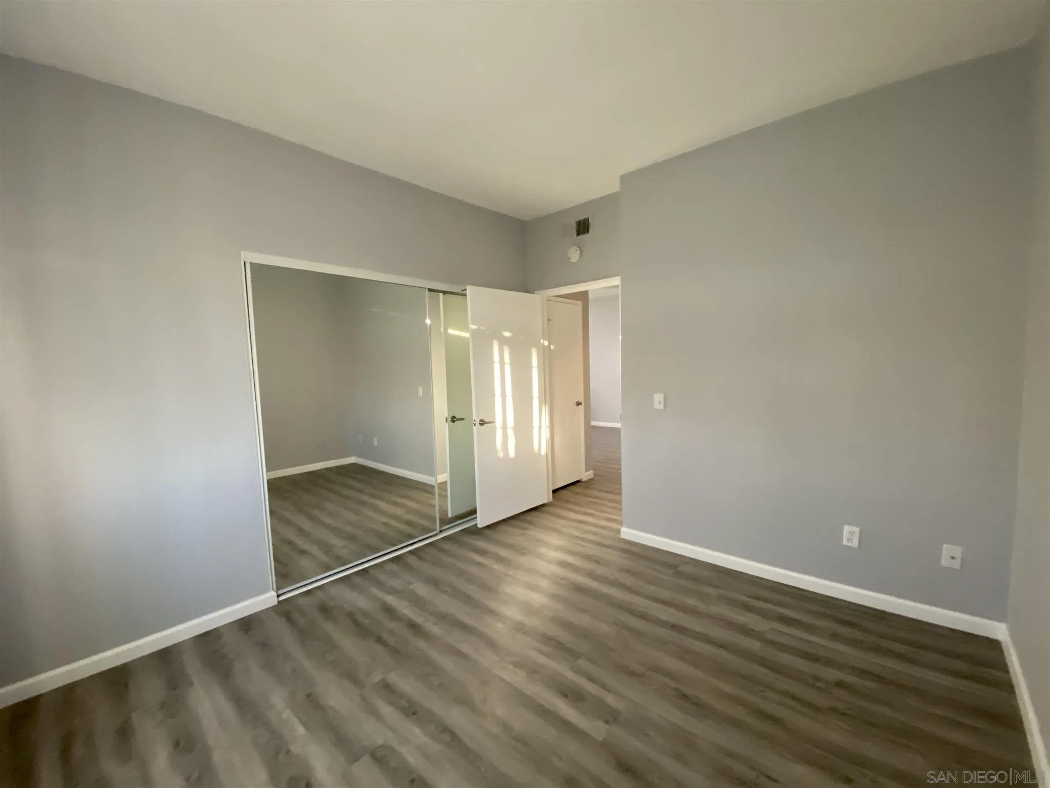 17161 Alva Road, Unit 213 San Diego, CA 92127 - Photo 9 of 48 a view of an empty room with wooden floor