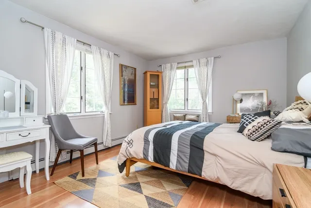 a bedroom with a bed chair and window