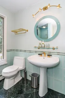 a bathroom with a sink a mirror and toilet