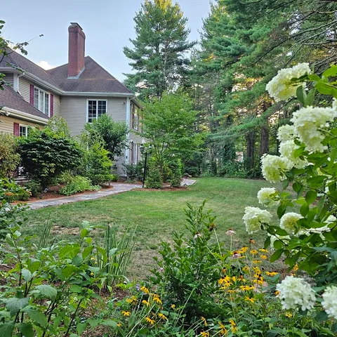 a view of a backyard with sitting area