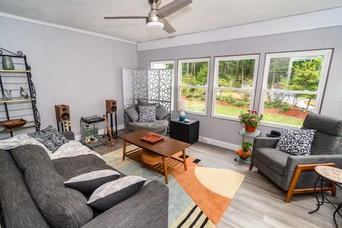 a living room with furniture and a large window
