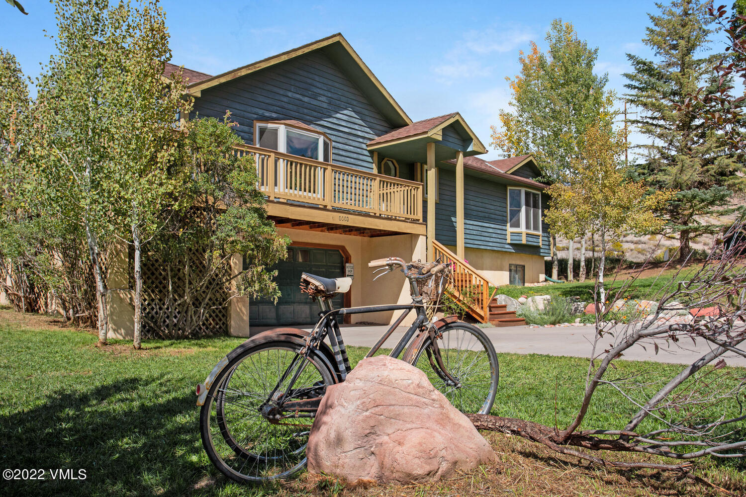a view of a house with backyard and sitting area