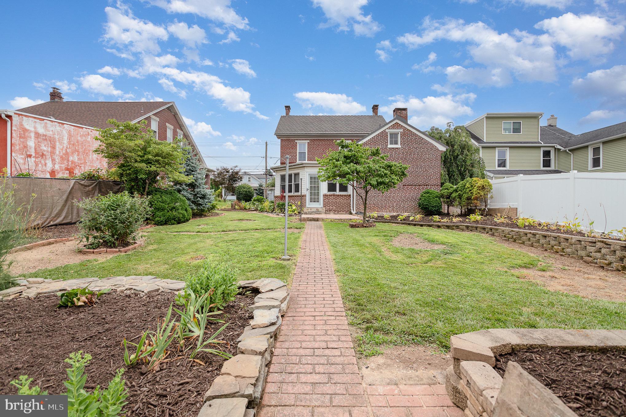 407 East Derry Road Hershey, PA 17033 - Photo 37 of 48 a front view of a house with a yard and potted plants