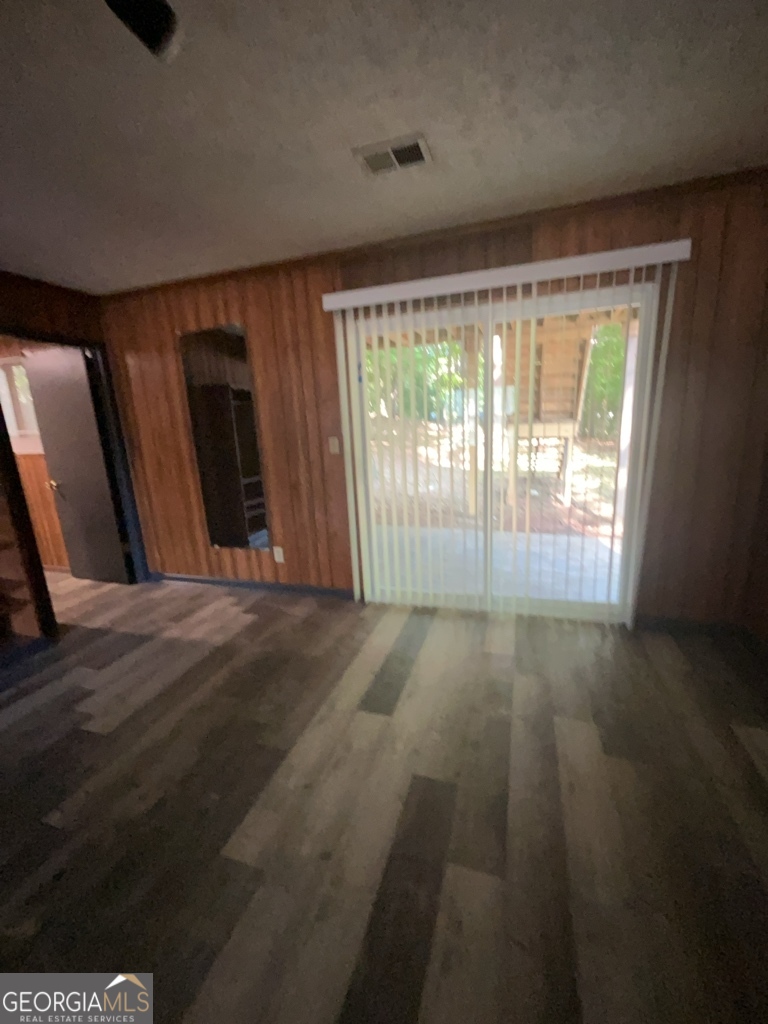 1265 Herrington Road Lawrenceville, GA 30044 - Photo 38 of 52 a view of an empty room with wooden floor and a window