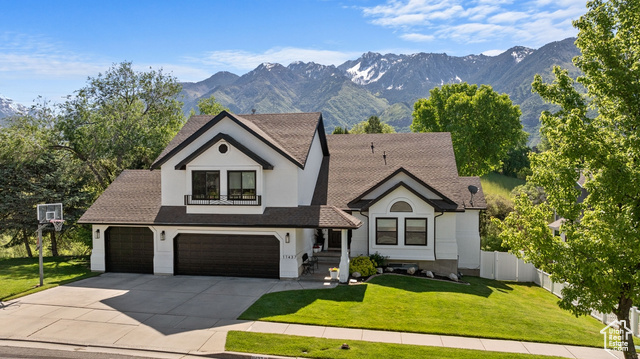 11437 Gracey Lane Sandy, UT 84092 - Photo 1 of 1 View of front of home with a garage, a front lawn, and a mountain view