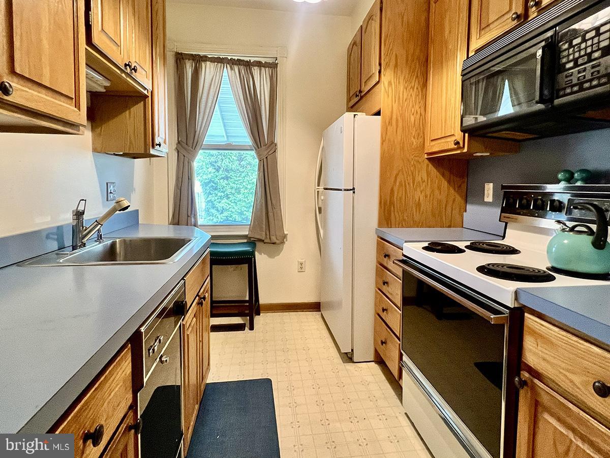 349 Chestnut Street West Reading, PA 19611 - Photo 11 of 23 a kitchen with a sink a stove and a refrigerator
