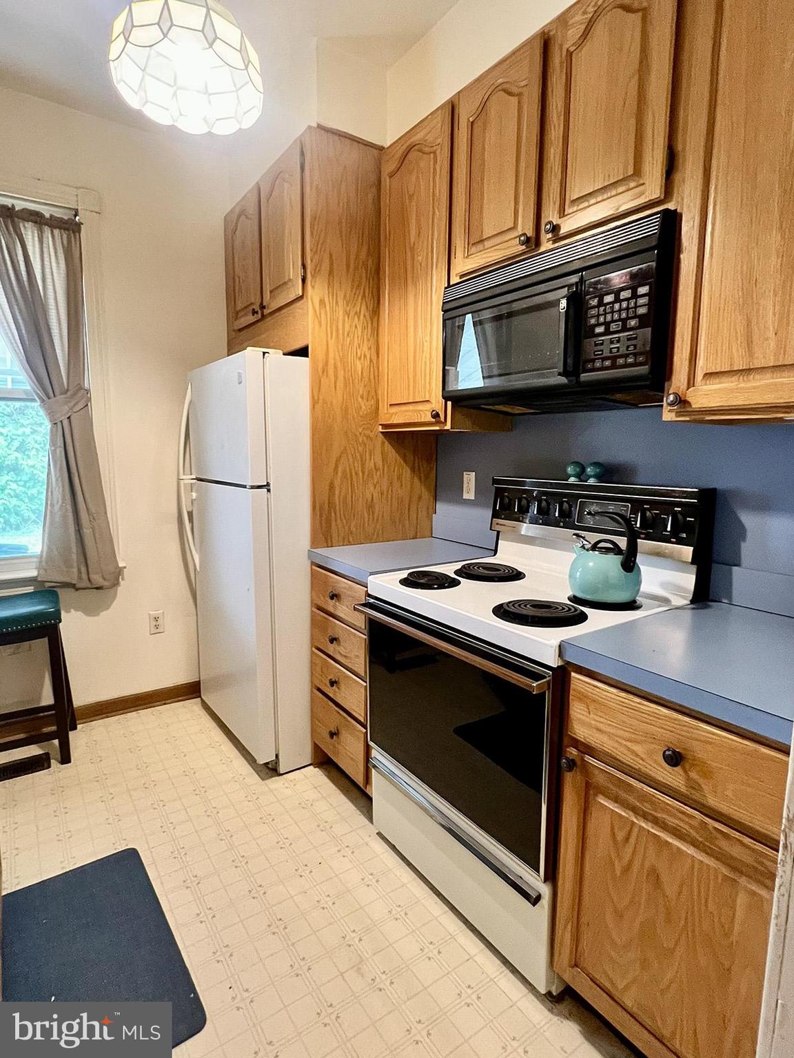 349 Chestnut Street West Reading, PA 19611 - Photo 13 of 23 a kitchen with stainless steel appliances granite countertop a stove a refrigerator and a microwave