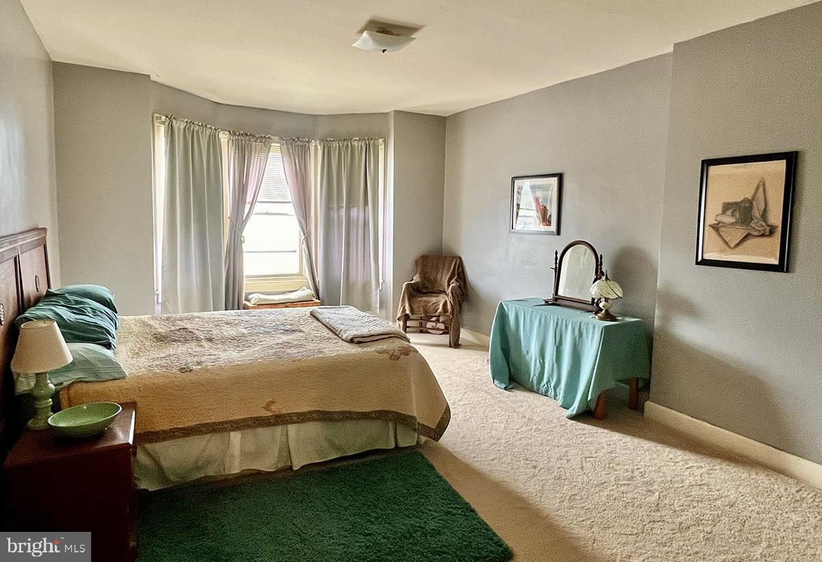 349 Chestnut Street West Reading, PA 19611 - Photo 14 of 23 a bedroom with a bed a bookshelf and a large window