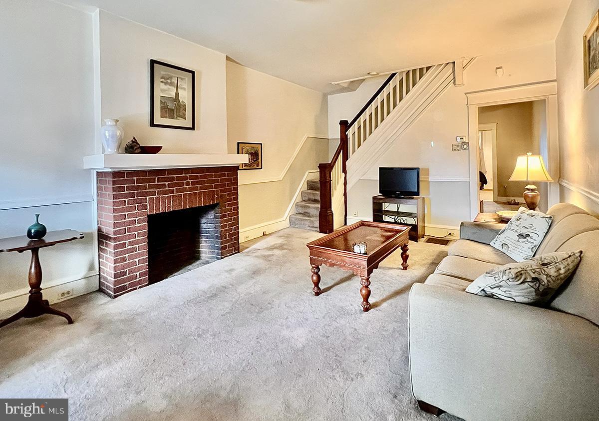 349 Chestnut Street West Reading, PA 19611 - Photo 6 of 23 a living room with furniture a fireplace and a flat screen tv