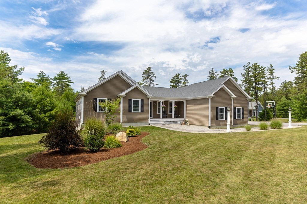 7 Pond Edge Trail Wareham, MA 02571 - Photo 1 of 30 a front view of a house with a yard and trees