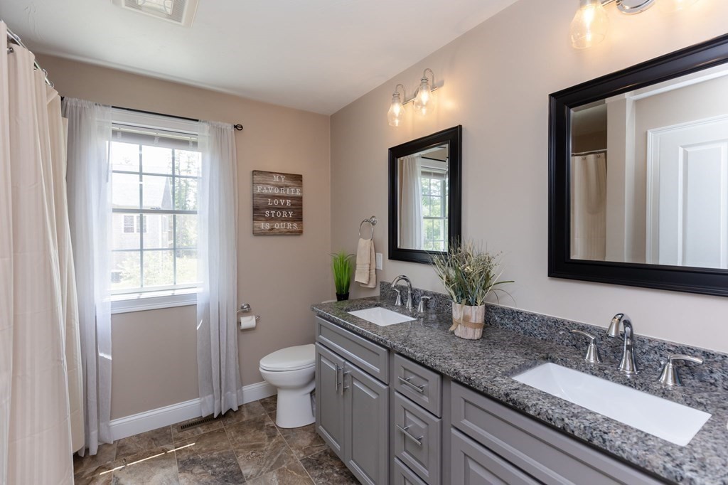 7 Pond Edge Trail Wareham, MA 02571 - Photo 24 of 30 a bathroom with double vanity sinks a toilet and a mirror