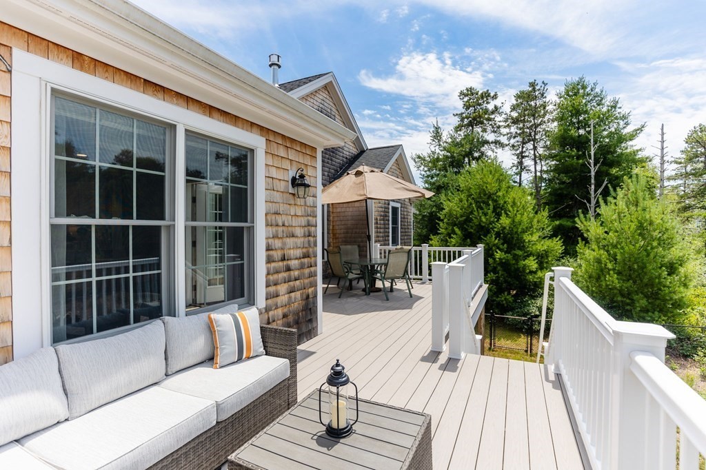 7 Pond Edge Trail Wareham, MA 02571 - Photo 28 of 30 a view of a deck with couches floor to ceiling window with wooden floor