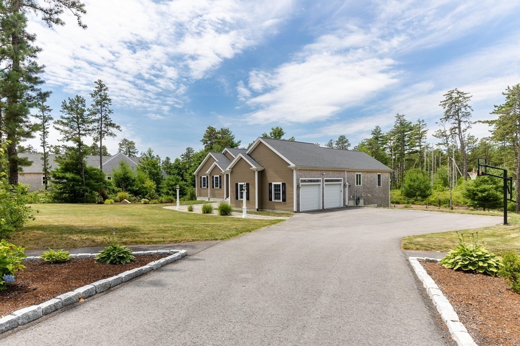 7 Pond Edge Trail Wareham, MA 02571 - Photo 4 of 30 a front view of a house with a yard and trees