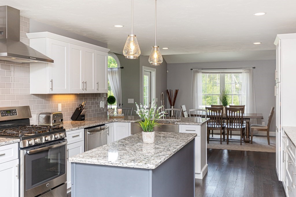 7 Pond Edge Trail Wareham, MA 02571 - Photo 5 of 30 a kitchen with sink cabinets and dining table