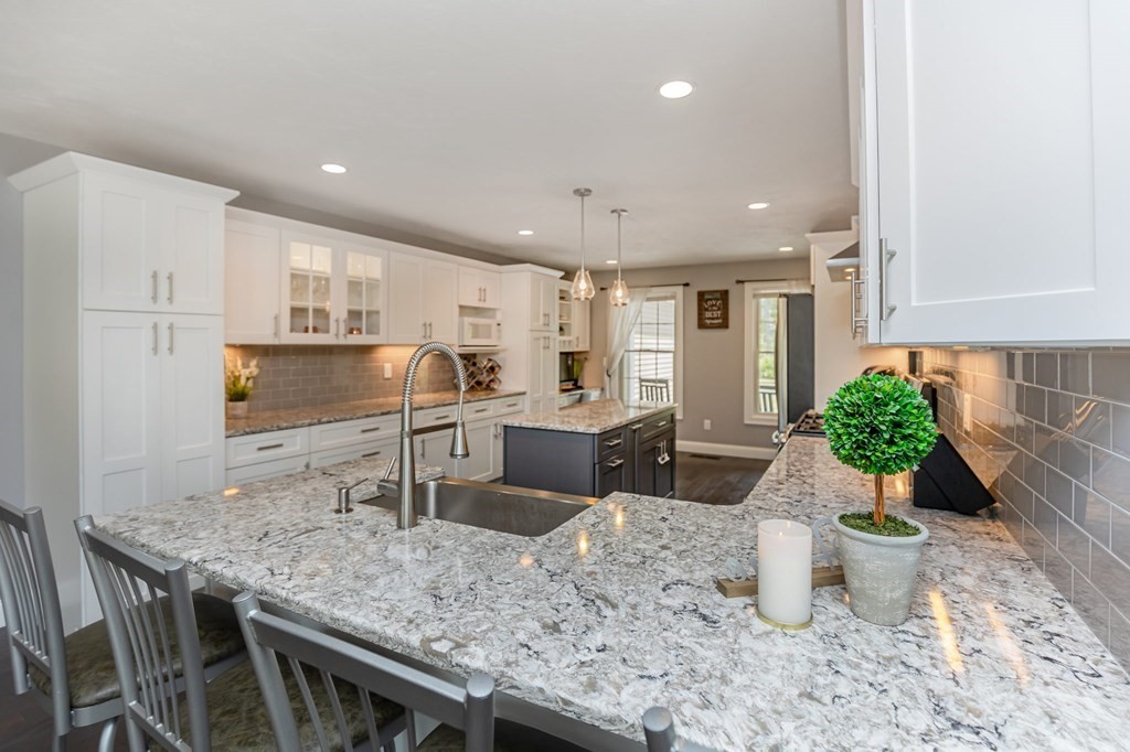 7 Pond Edge Trail Wareham, MA 02571 - Photo 7 of 30 a kitchen with stainless steel appliances granite countertop sink stove top oven and microwave