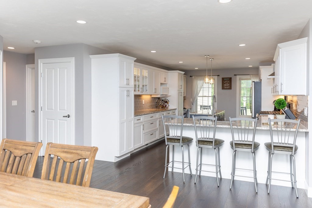 7 Pond Edge Trail Wareham, MA 02571 - Photo 8 of 30 a kitchen with stainless steel appliances kitchen island granite countertop a refrigerator and cabinets