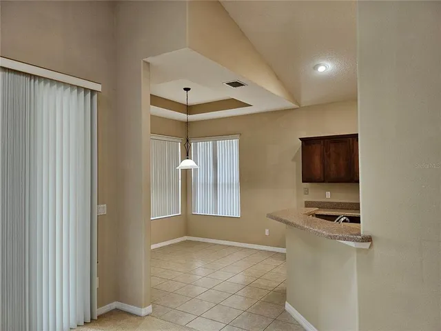 a view of kitchen with stainless steel appliances a refrigerator and cabinets