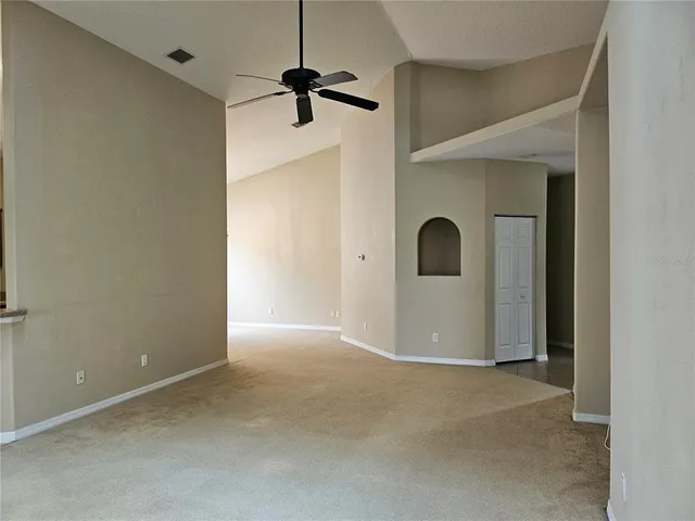 a view of a room with a ceiling fan