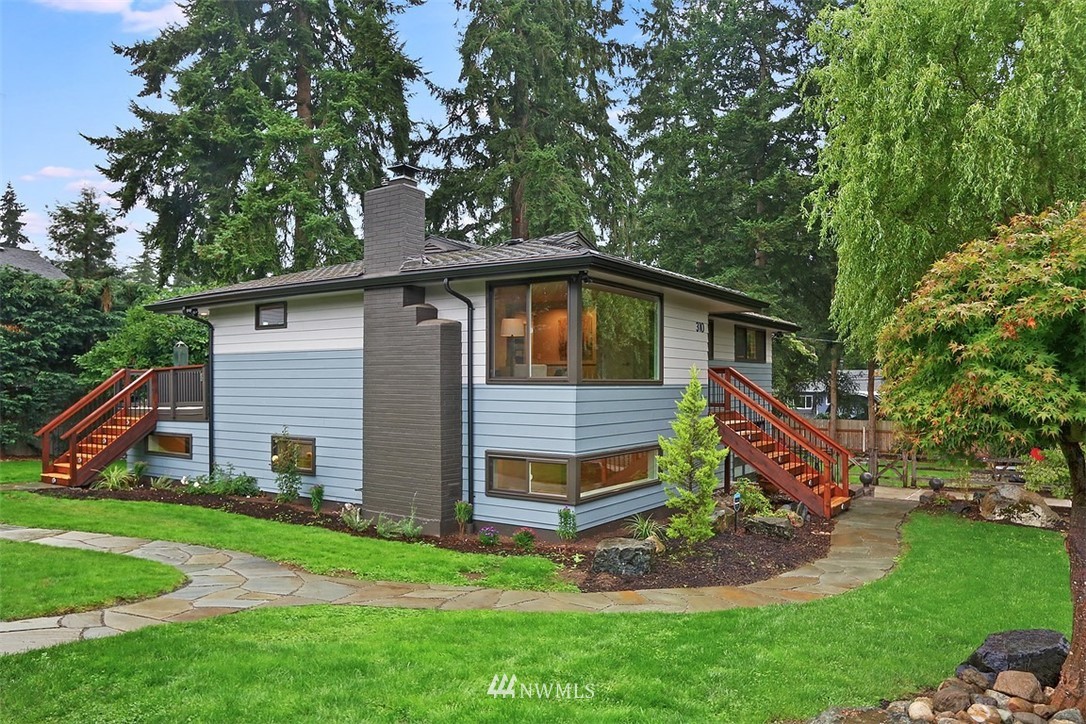 310 175th Place Southwest Bothell, WA 98012 - Photo 1 of 40 a backyard of a house with wooden fence and large trees