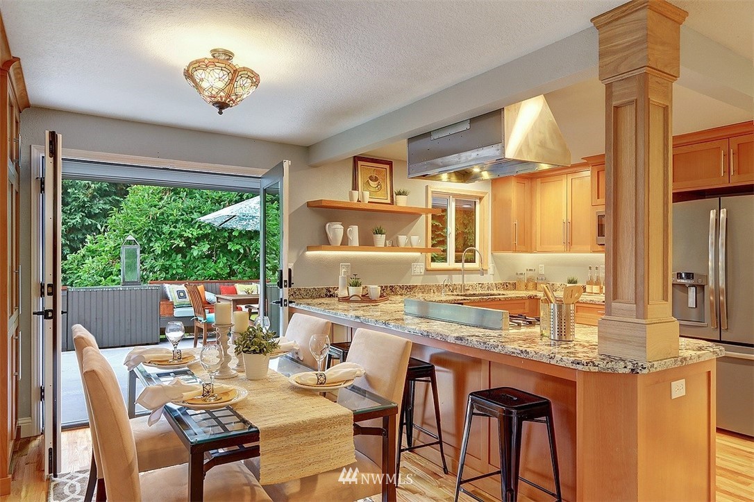 310 175th Place Southwest Bothell, WA 98012 - Photo 7 of 40 a dining room with furniture a large window and a chandelier