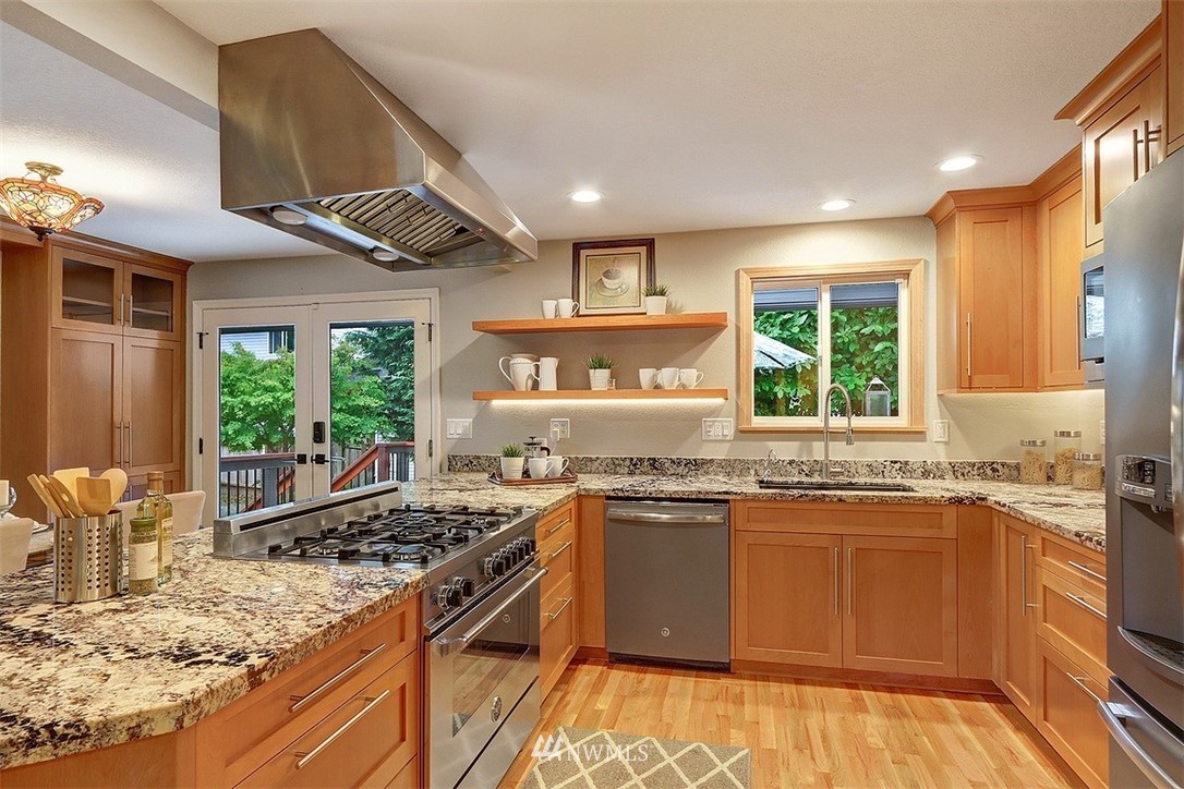 310 175th Place Southwest Bothell, WA 98012 - Photo 9 of 40 a kitchen with stainless steel appliances granite countertop a stove and a sink
