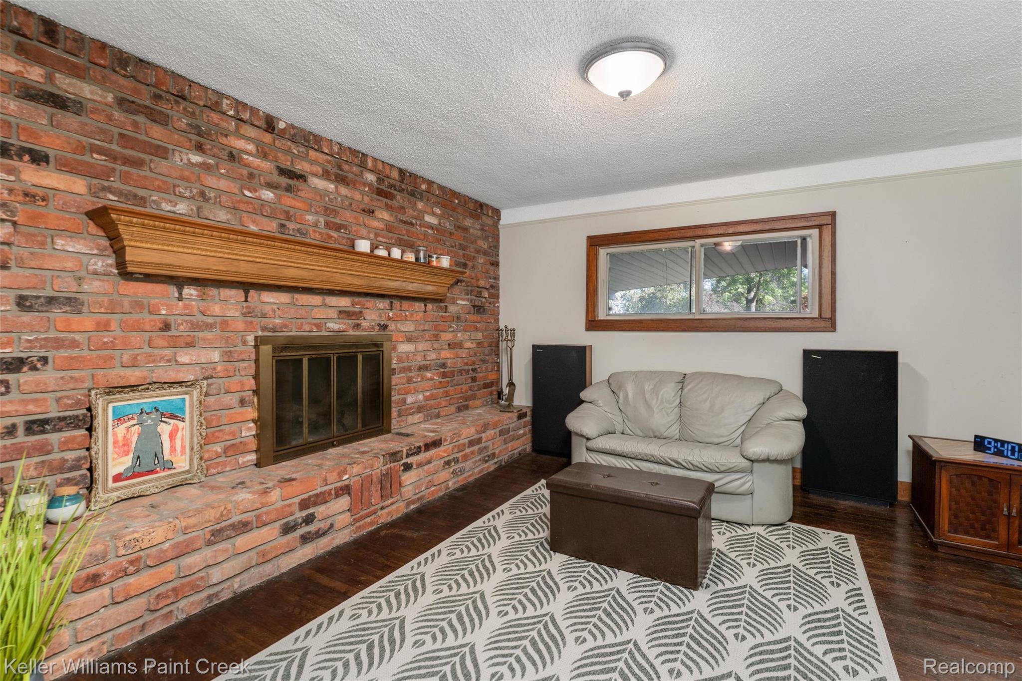 328 Ferndale Avenue Rochester, MI 48307 - Photo 19 of 54 Brick fireplace with a wood mantel, dark wood-finish flooring, and a cased window