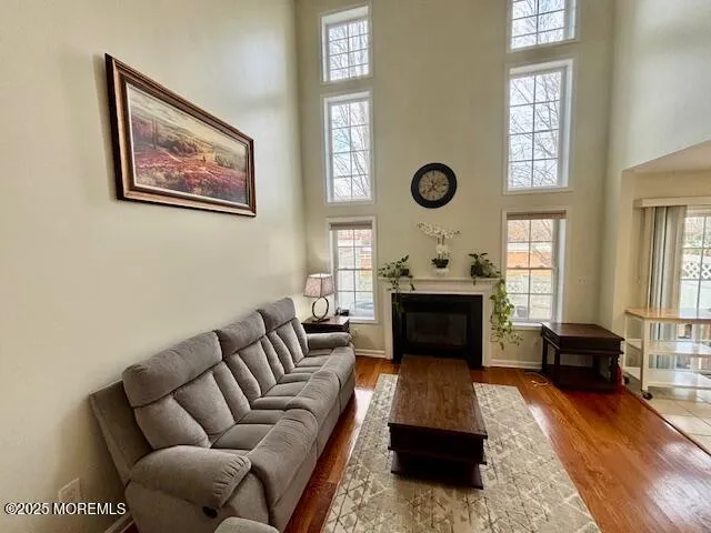 a living room with furniture a fireplace and a window