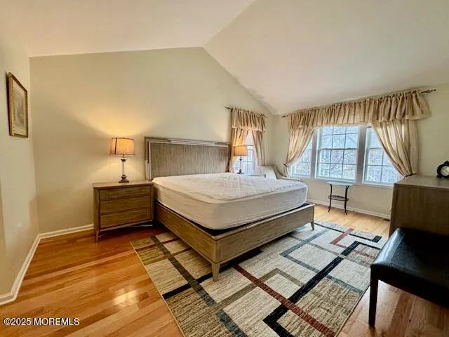 a bedroom with a bed window and a night stand
