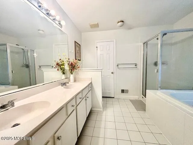 a spacious bathroom with a shower sink and mirror