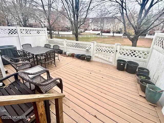 a view of a roof deck with table and chairs and wooden floor