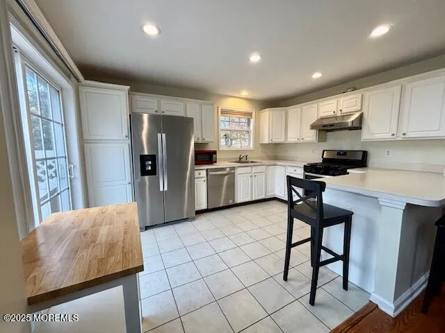 a kitchen with stainless steel appliances granite countertop a refrigerator sink and cabinets
