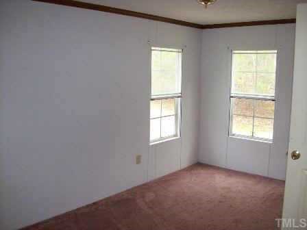 322 Gabriel Jones Road Roxboro, NC 27574 - Photo 11 of 12 an empty room with windows