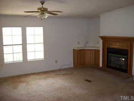 322 Gabriel Jones Road Roxboro, NC 27574 - Photo 8 of 12 an empty room with windows and fireplace
