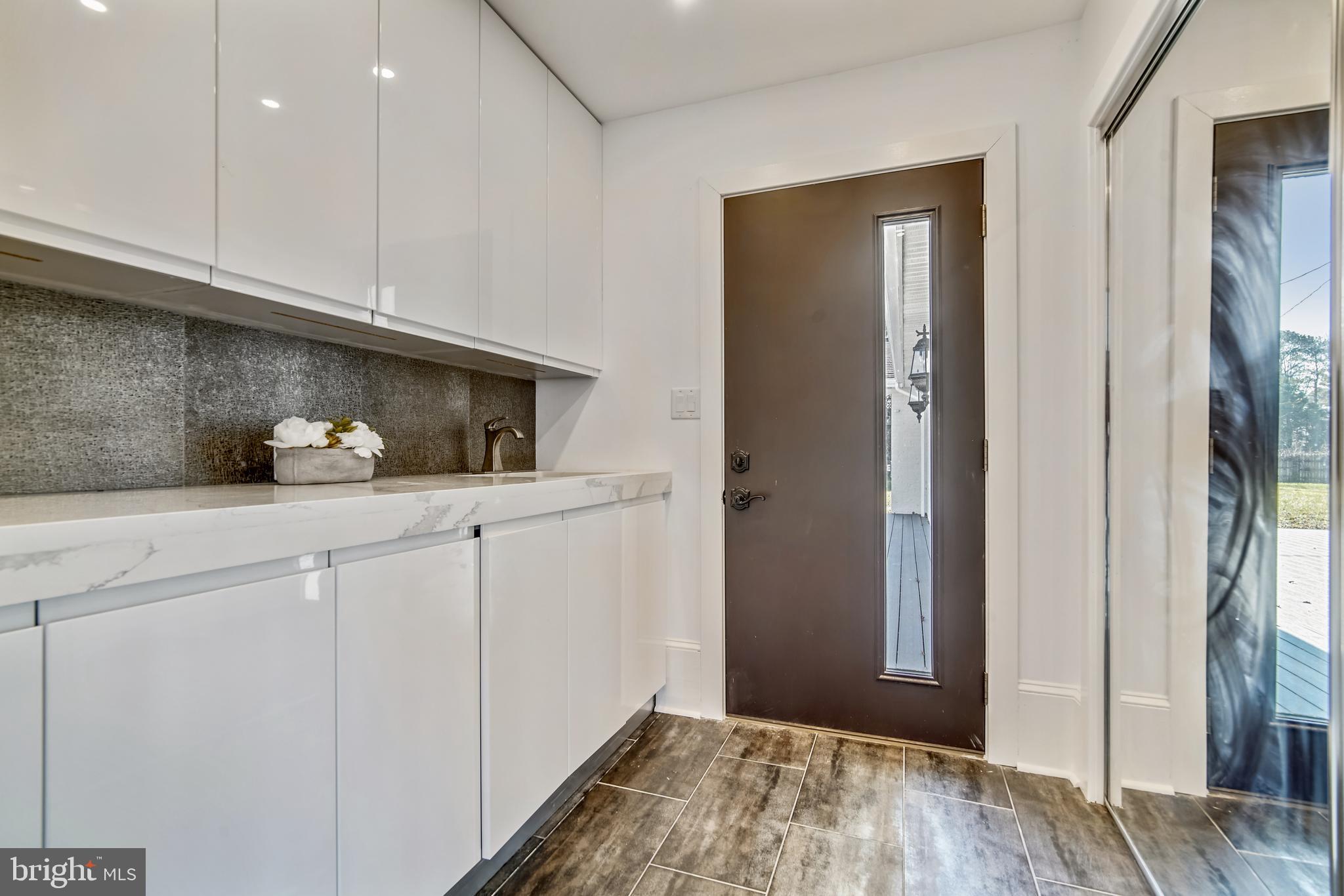 48777 Carvels Way Ridge, MD 20680 - Photo 27 of 35 Laundry Room with access to front exterior