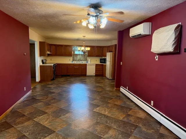 a kitchen with kitchen island a counter top space appliances and cabinets