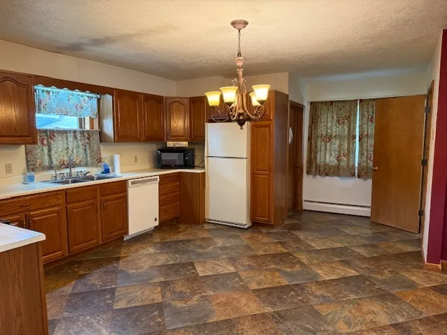 a bathroom with a white toilet sink and vanity