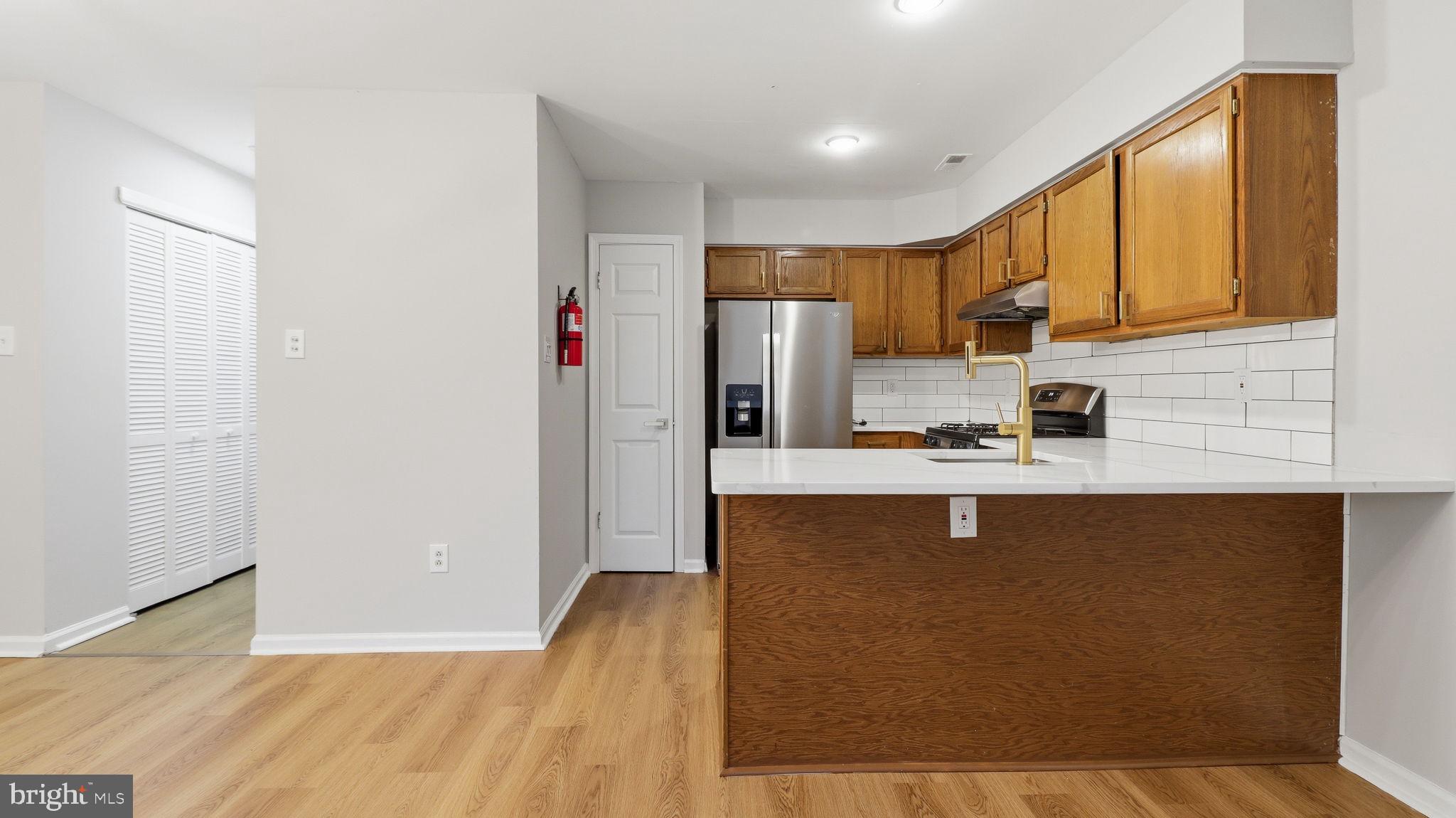 5106 Tall Pines Pine Hill, NJ 08021 - Photo 15 of 35 Modern kitchen with warm wood accents.