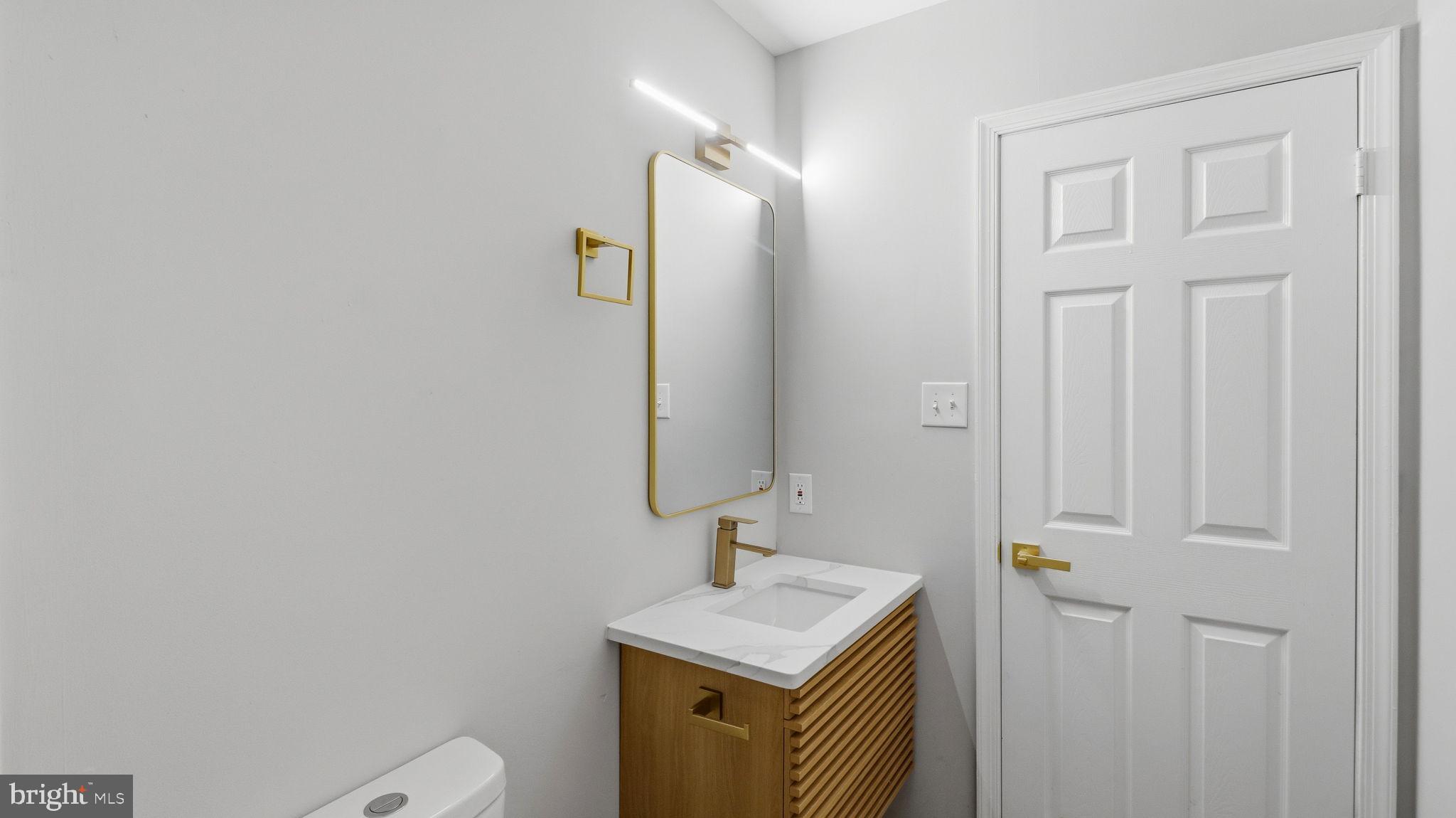 5106 Tall Pines Pine Hill, NJ 08021 - Photo 34 of 35 Sleek modern bathroom with gold accents.