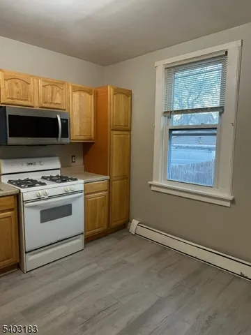 a kitchen with stainless steel appliances a stove a sink and a refrigerator