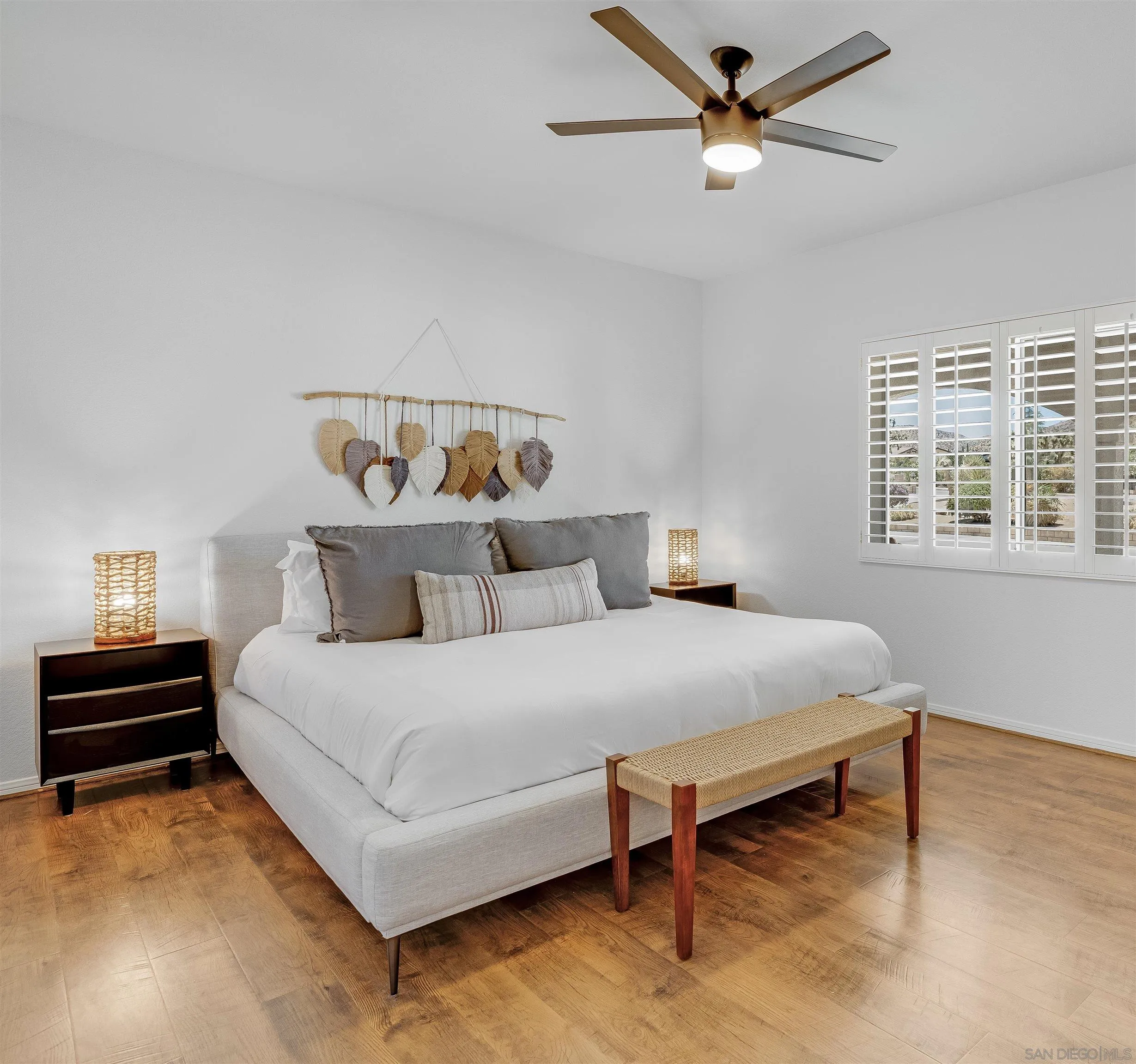 9255 Del Monte Avenue Yucca Valley, CA 92284 - Photo 24 of 46 a bedroom with a bed and a chandelier