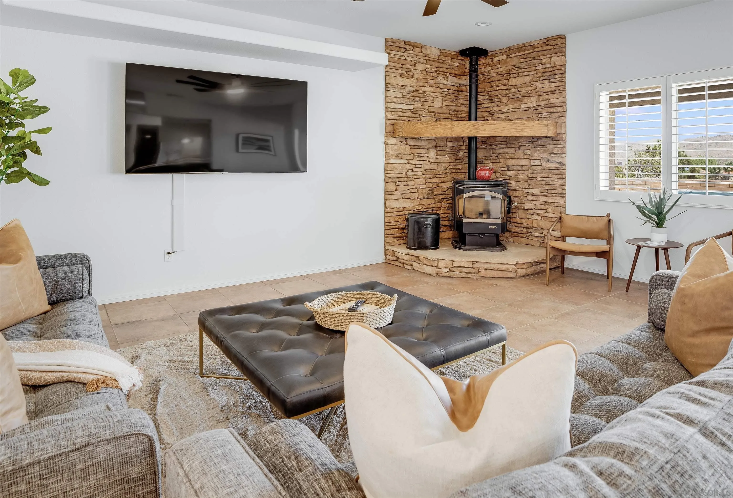 9255 Del Monte Avenue Yucca Valley, CA 92284 - Photo 30 of 46 a living room with furniture and a flat screen tv