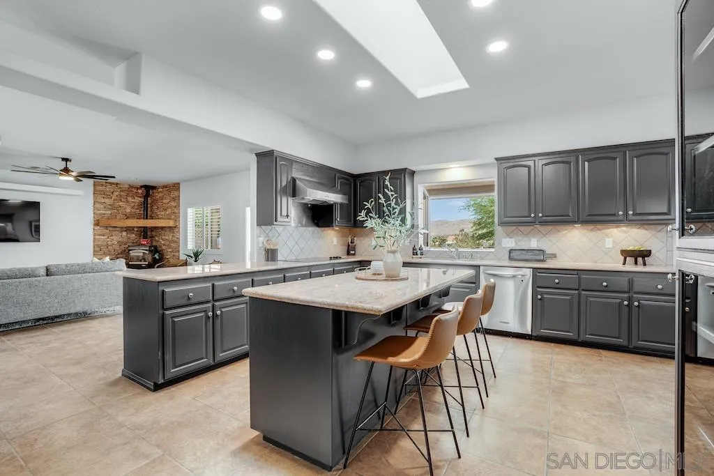9255 Del Monte Avenue Yucca Valley, CA 92284 - Photo 3 of 46 a kitchen with stainless steel appliances kitchen island granite countertop a sink and cabinets