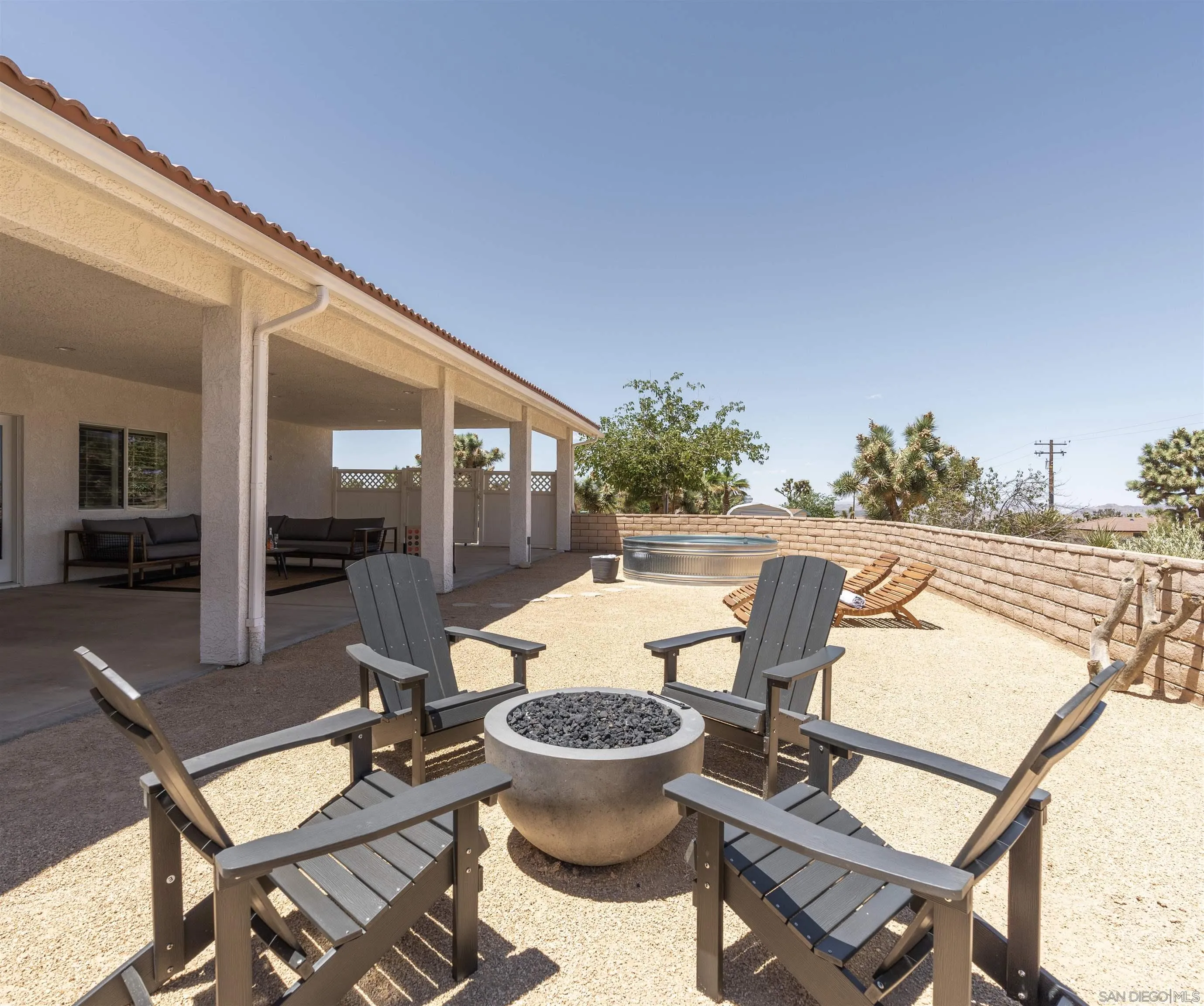 9255 Del Monte Avenue Yucca Valley, CA 92284 - Photo 35 of 46 a view of a patio with chairs and table